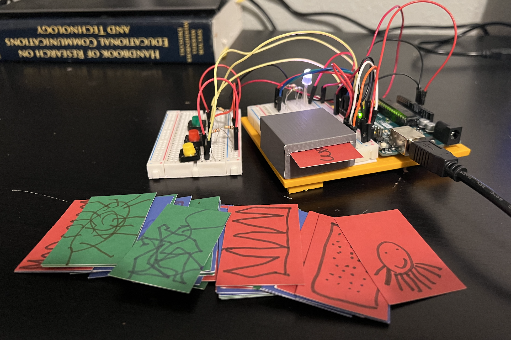 circuit board and breadbox with a box. colored cards in the foreground